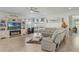 Bright living room with sleek sofas, modern entertainment center featuring a fireplace, and large windows at 1880 Bonser Rd, Minneola, FL 34715