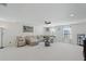 Spacious living room featuring a sectional sofa, ceiling fan and neutral decor at 1880 Bonser Rd, Minneola, FL 34715