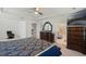 Expansive main bedroom featuring dark wood furniture, neutral carpet, and an attached bathroom at 1880 Bonser Rd, Minneola, FL 34715