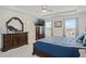 Bright main bedroom featuring dark wood furniture, carpet, and windows with blinds at 1880 Bonser Rd, Minneola, FL 34715