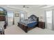 Spacious main bedroom with decorative ceiling, ceiling fan, and a view of the outside at 1880 Bonser Rd, Minneola, FL 34715