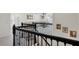 Staircase featuring black wrought iron railings and neutral carpeting and living room at 1880 Bonser Rd, Minneola, FL 34715
