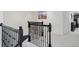 Staircase featuring black wrought iron railings and neutral carpeting leading to the second floor at 1880 Bonser Rd, Minneola, FL 34715