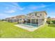 Expansive backyard with well-maintained lawn, patio and screened pool area, ideal for outdoor activities and entertaining at 210 Vista Loop, Davenport, FL 33897