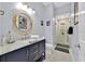 Stylish bathroom with modern vanity, framed mirror, and glass-enclosed shower at 210 Vista Loop, Davenport, FL 33897