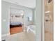 Bathroom with a soaking tub next to shower and view into the bedroom at 210 Vista Loop, Davenport, FL 33897