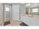 Bright bathroom features double sinks, a large mirror, and tiled floors at 210 Vista Loop, Davenport, FL 33897