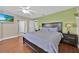 Large bedroom features a ceiling fan, TV, hardwood floors, and calming colors at 210 Vista Loop, Davenport, FL 33897