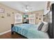 Comfortable bedroom with a ceiling fan, TV, and a queen-sized bed and dark wood floors at 210 Vista Loop, Davenport, FL 33897