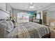Bedroom with TV over a dresser and a view of the en suite bathroom at 210 Vista Loop, Davenport, FL 33897