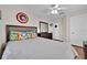 Inviting bedroom with hardwood floors, ceiling fan, and comic-themed artwork, adding personality to the space at 210 Vista Loop, Davenport, FL 33897