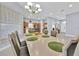 Bright dining room area with modern chandelier and open access to other living spaces at 210 Vista Loop, Davenport, FL 33897