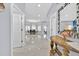 Open entryway with gleaming tile floors leading to the dining room with a chandelier and abundant natural light at 210 Vista Loop, Davenport, FL 33897