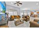 Bright living room showcases tile flooring, two sofas, and access to the dining area at 210 Vista Loop, Davenport, FL 33897