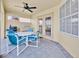 Covered patio features a ceiling fan and furniture, perfect for outdoor living at 210 Vista Loop, Davenport, FL 33897