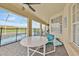 Covered patio with furniture overlooking the backyard swimming pool at 210 Vista Loop, Davenport, FL 33897