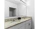 Bathroom featuring double vanity with granite countertop and a big mirror at 219 Meghan Cir, Deland, FL 32724