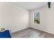 Bedroom featuring wood-look flooring, one window with a zebra staring into the property at 219 Meghan Cir, Deland, FL 32724