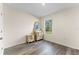 Bright bedroom featuring wood floors, a window with a view, and a dresser with mirror at 219 Meghan Cir, Deland, FL 32724