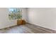 Bright bedroom featuring wood-look flooring and a large window with a view of the trees outside at 219 Meghan Cir, Deland, FL 32724