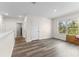 Bonus room with wood-look flooring, a big window with a view and a hall with several doors at 219 Meghan Cir, Deland, FL 32724