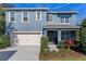 Inviting two-story home showcasing a 2-car garage and well-manicured landscaping, creating curb appeal at 219 Meghan Cir, Deland, FL 32724