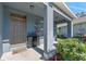 Cozy front porch featuring decorative accents, stylish furnishings, and lush landscaping, enhancing curb appeal at 219 Meghan Cir, Deland, FL 32724