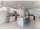 Bright kitchen featuring white cabinets, stainless steel appliances, and a granite countertop island with bar stool seating at 219 Meghan Cir, Deland, FL 32724