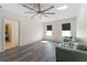 Comfortable living room featuring wood floors, a ceiling fan, and a sofa for relaxing or entertaining at 219 Meghan Cir, Deland, FL 32724