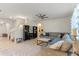 Comfortable living room with tile floors, a ceiling fan, a cozy sectional sofa, and decorative bookshelves at 219 Meghan Cir, Deland, FL 32724