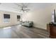Comfortable living room featuring wood floors, a ceiling fan, and natural light at 219 Meghan Cir, Deland, FL 32724