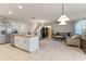 Open floor plan showcasing the kitchen island and living room area with a comfortable gray sectional sofa at 219 Meghan Cir, Deland, FL 32724
