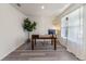 Bright and airy home office with wood floors, contemporary chandelier, and large window, ideal for focus at 219 Meghan Cir, Deland, FL 32724