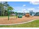 Community playground with swings, slide, and green space at 219 Meghan Cir, Deland, FL 32724