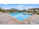 Beautiful community pool with lounge chairs and umbrellas at 219 Meghan Cir, Deland, FL 32724