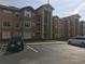 Apartment building with multiple floors and cars parked in the parking lot at 2207 Antigua Pl # 736, Kissimmee, FL 34741
