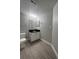 Bathroom featuring a vanity with a black countertop and wooden-look tiled flooring at 2207 Antigua Pl # 736, Kissimmee, FL 34741