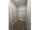 Walk-in closet featuring sleek wood-look floors and ample shelving at 2207 Antigua Pl # 736, Kissimmee, FL 34741