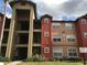 Apartment building with well-maintained landscaping and private balconies at 2207 Antigua Pl # 736, Kissimmee, FL 34741