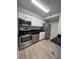 Bright kitchen featuring stainless steel appliances and stylish black countertops at 2207 Antigua Pl # 736, Kissimmee, FL 34741