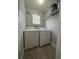 Laundry room with a washer and dryer, shelving, and a window at 2207 Antigua Pl # 736, Kissimmee, FL 34741