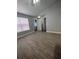 Spacious bedroom with wood-look floors and ceiling fan, leading to laundry area at 2207 Antigua Pl # 736, Kissimmee, FL 34741