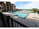Community pool featuring ample seating, a lake view, and meticulously kept pavers at 2207 Antigua Pl # 736, Kissimmee, FL 34741