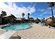 Community pool featuring lounge chairs, tropical landscaping and inviting clubhouse in a picturesque setting at 2207 Antigua Pl # 736, Kissimmee, FL 34741