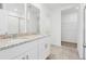 Bright bathroom featuring dual sinks, granite counters, white cabinets, and tile floor at 2310 White Tail St, Davenport, FL 33837