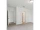 An additional bedroom showcases a neutral palette, carpeted floor and bathroom access at 2310 White Tail St, Davenport, FL 33837
