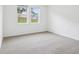 Bright bedroom with neutral carpet, and fresh paint, naturally lit with windows overlooking the lawn at 2310 White Tail St, Davenport, FL 33837