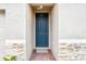 A blue painted front door with brickwork surrounding it at 2310 White Tail St, Davenport, FL 33837