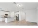 An open-concept kitchen with white cabinetry, stainless steel appliances and a breakfast bar at 2310 White Tail St, Davenport, FL 33837