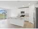Open concept kitchen with granite counters, island, and stainless steel appliances at 2310 White Tail St, Davenport, FL 33837